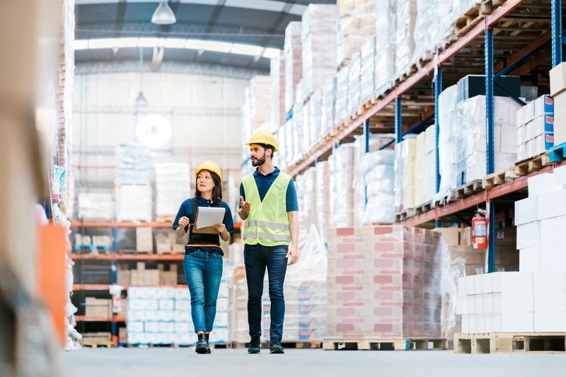 2 people in warehouse managing inventory and procurement