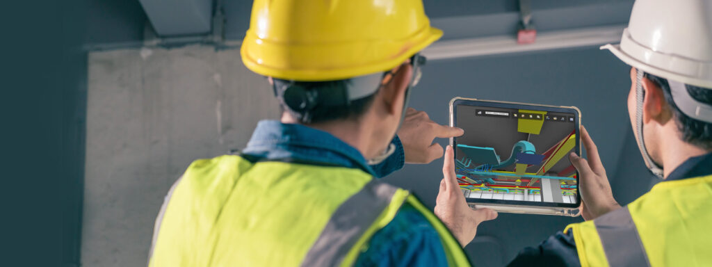 Two workers using a tablet or iPad with an AR assisted application