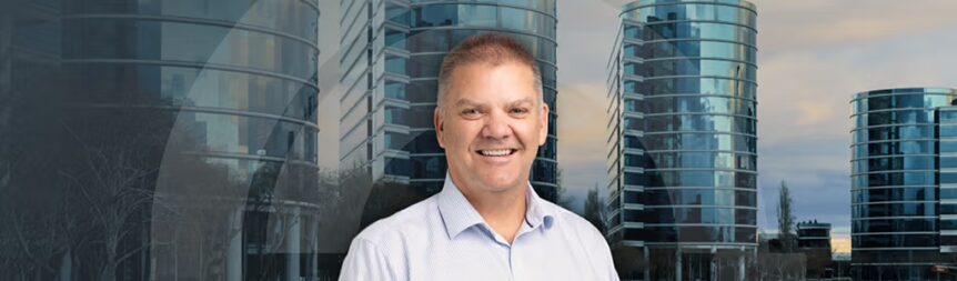 A picture of Craig Lefoe of a background of city landscape