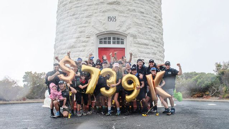 Group of people celebrating the completion of their trek on the Cape2Cape event.