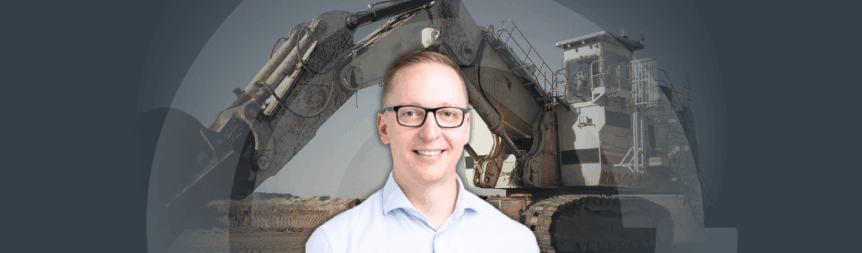 A picture of Josh Old with an excavator in the background