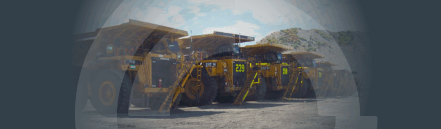 Banner background image of a fleet of haul trucks at a mine site