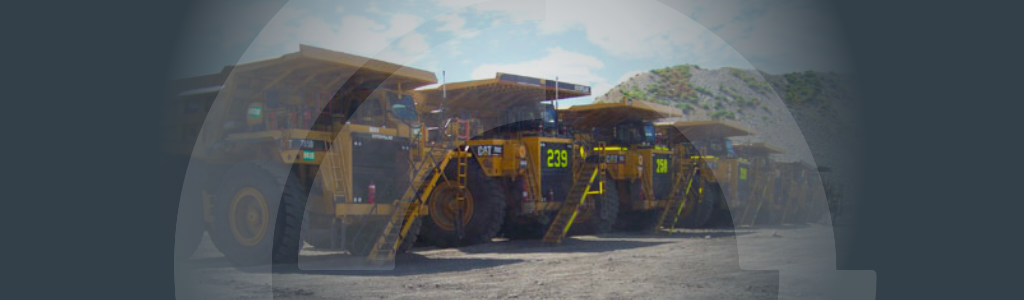 Banner-How The Right Fleet Strategy Reduces Business Costs Banner background image of a fleet of haul trucks at a mine site
