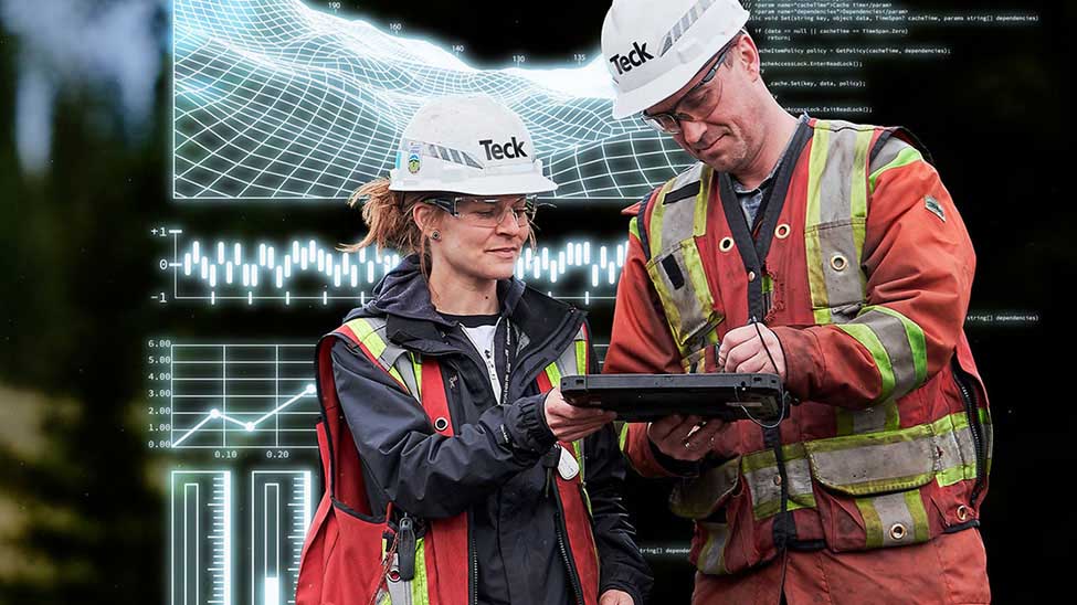 image of 2 Teck Resources employees discussing analytics and data