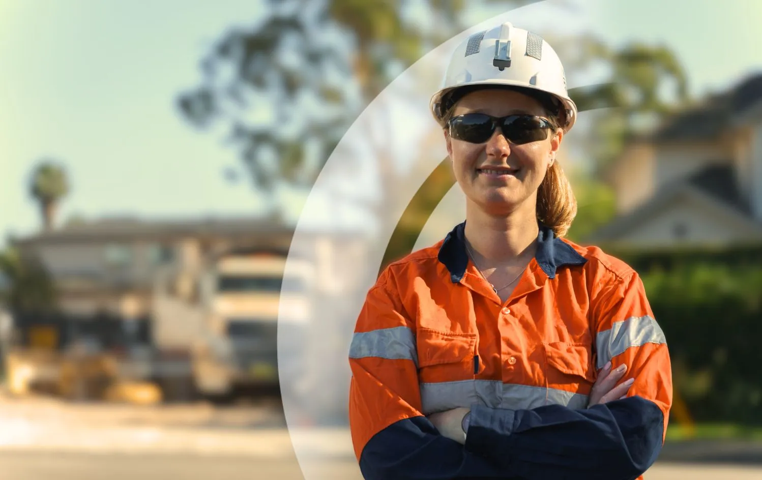 Female electrical engineer in Australian suburbs, smiling at camera.